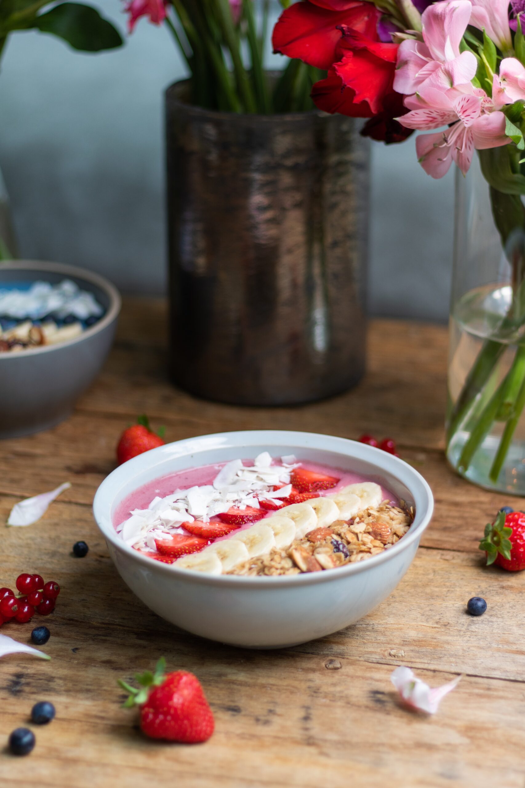 A vertical shot of a healthy smoothie bowl with fruits and granola